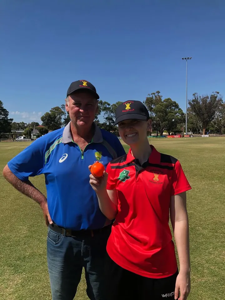 Ellanor Carboon holding the hat-trick ball with her dad Mark
