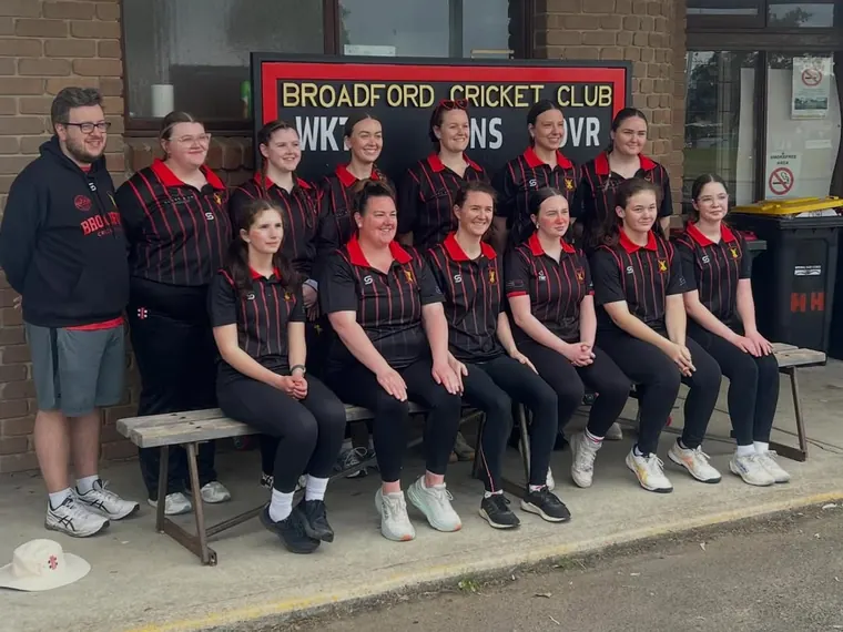 Broadford's first women's team in red and black outside the clubrooms